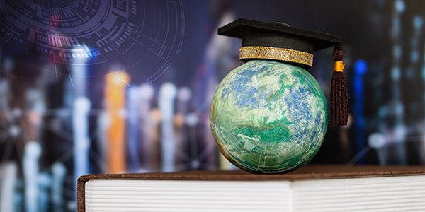 A small globe wearing a black graduation cap with a gold trim sitting on top of a book, set against a futuristic digital backdrop.